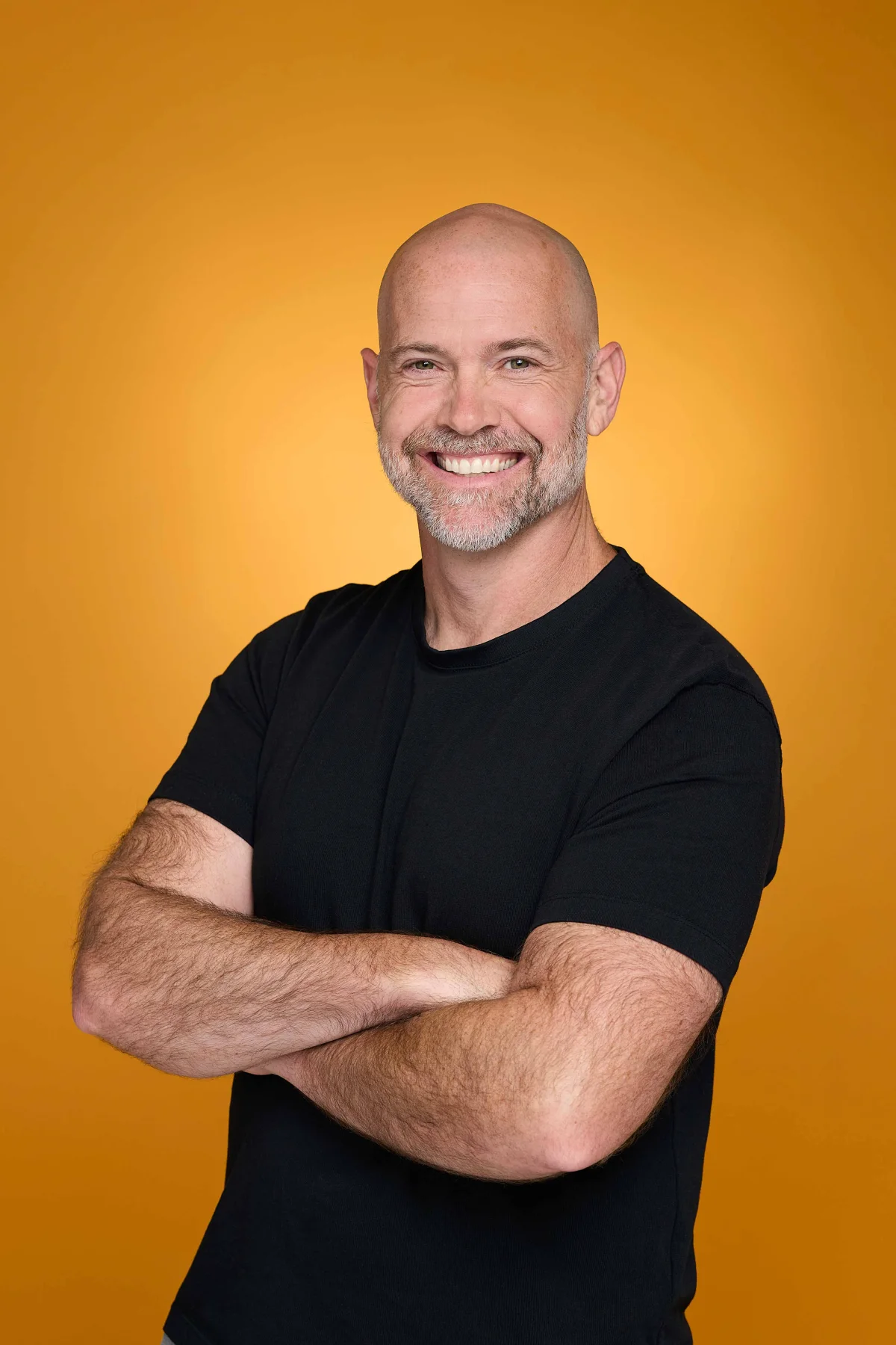 Bronkar Lee smiling with his arms crossed